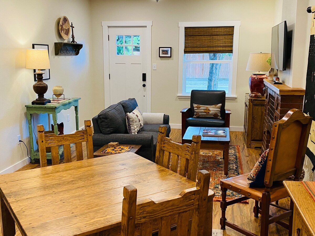 Living and dining area with wooden table and chairs