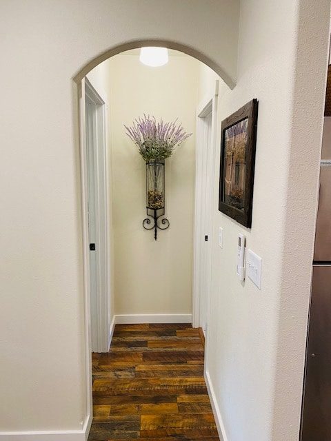 Arched hallway with a wall sconce of lavender